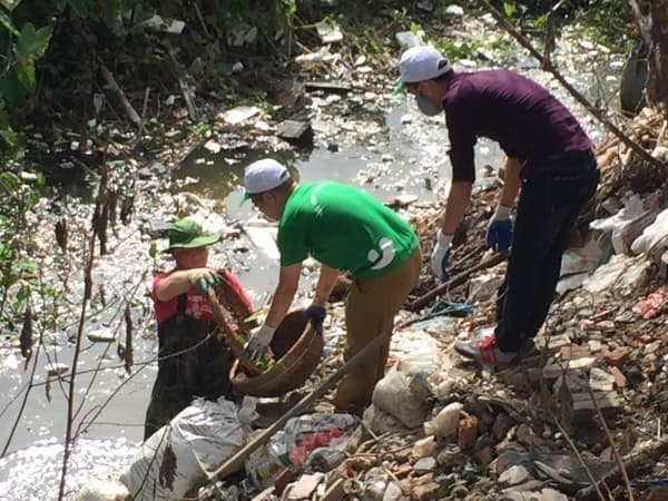 James và các thành viên của Thu Cúc cùng nhau lội xuống con mương bị ô nhiễm để nhặt rác